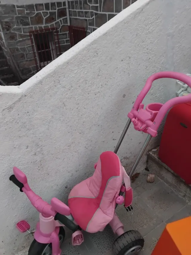 Triciclo infantil rosa con empujador