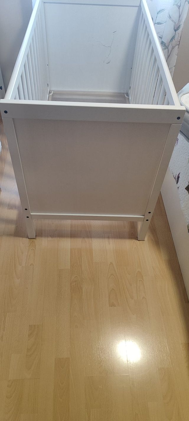 Cuna colecho blanca IKEA con colchón y barandilla.