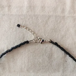 Collana perline fiocco pendente