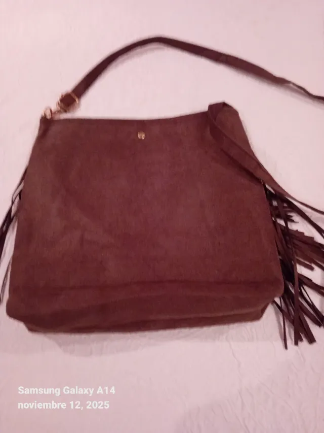 Bolso bandolera de color marrón con flecos.