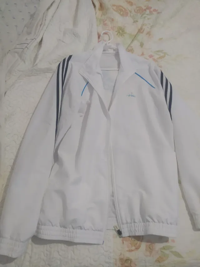 Sudadera Adidas Blanca y azul con rayas negras.
