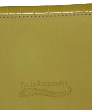 Cartera de piel amarilla con detalle joya