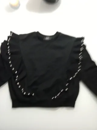 Sudadera negra con volantes y pedrería