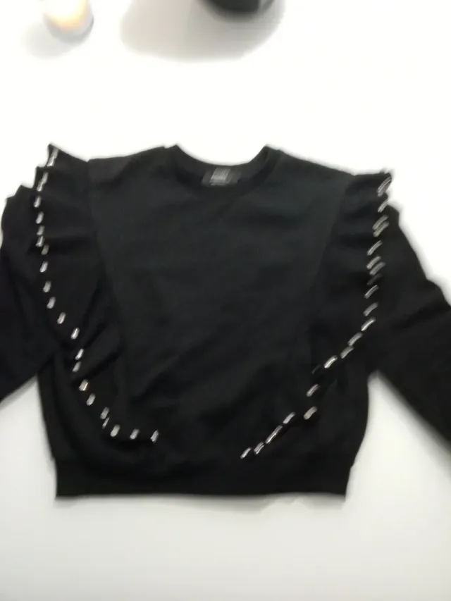 Sudadera negra con volantes y pedrería