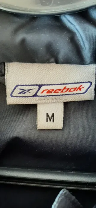 Cortavientos Reebok Unisex azul marino con capucha