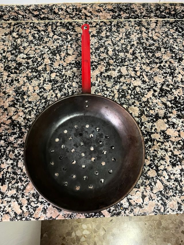 Asador de castañas con mango rojo