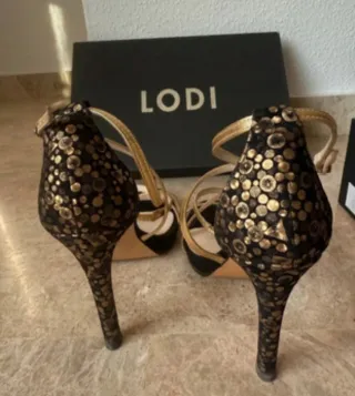Sandalias Lodi fiesta negras y doradas Negociable