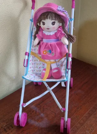 Cochecito de muñecas rosa y blanco