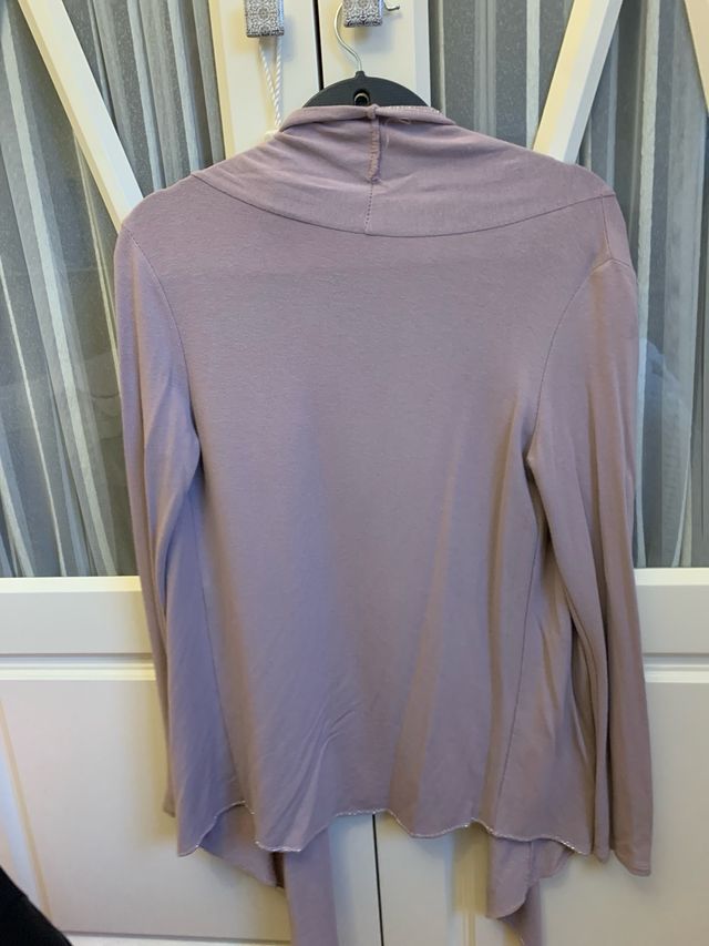 Chaqueta rosa palo con pespunte plateado.