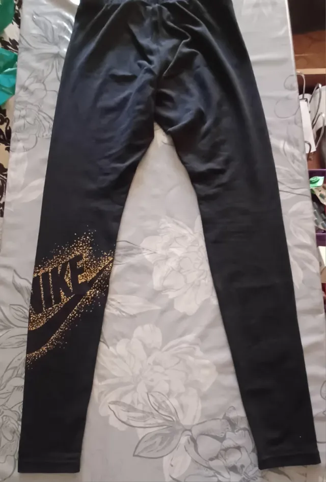 Mallas deportivas Nike negras con detalles dorados