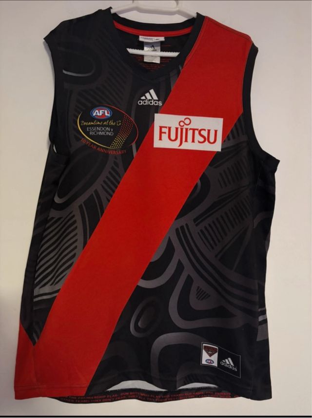 Camiseta AFL Essendon Bombers – Edição Indígena