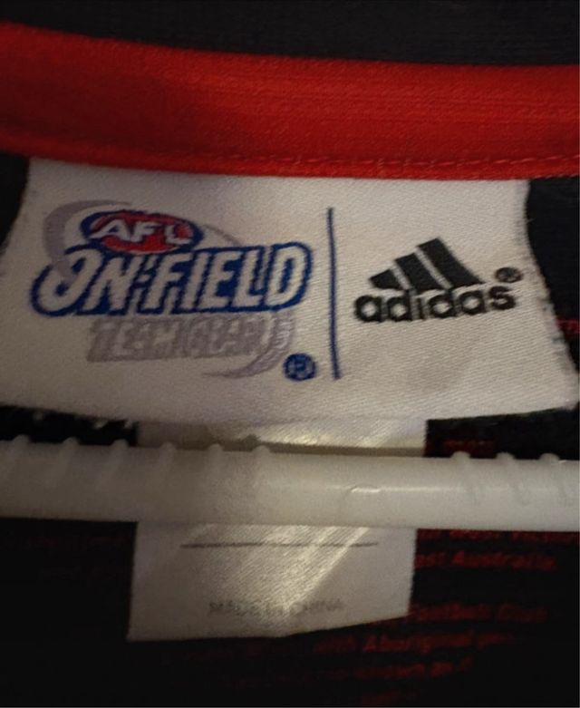 Camiseta AFL Essendon Bombers – Edição Indígena