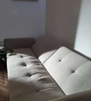 Sofá cama gris con funda nueva