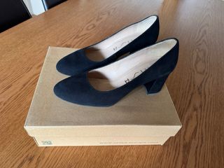 Zapatos de tacón negros ante mujer