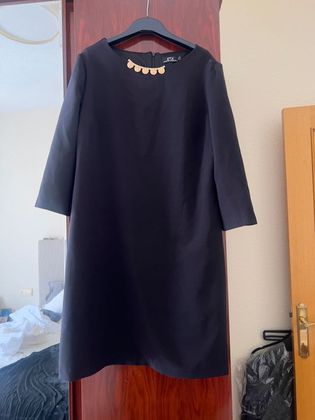 Vestido negro elegante con detalle dorado