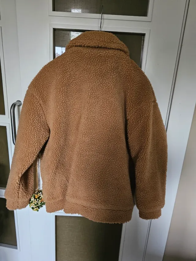 Chaqueta corta de borreguito en color tostado.