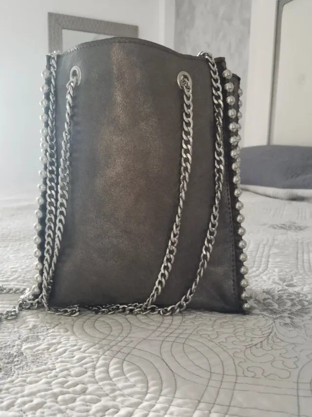 Bolso plateado con cadenas y tachuelas