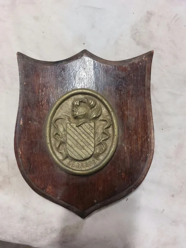Metopa de madera con escudo metálico
