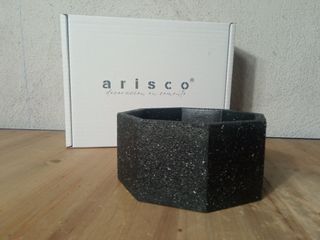 Pezzo ottagonale in cemento di colore granito.