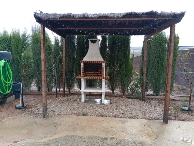 Barbacoa de ladrillo y hormigón con pérgola