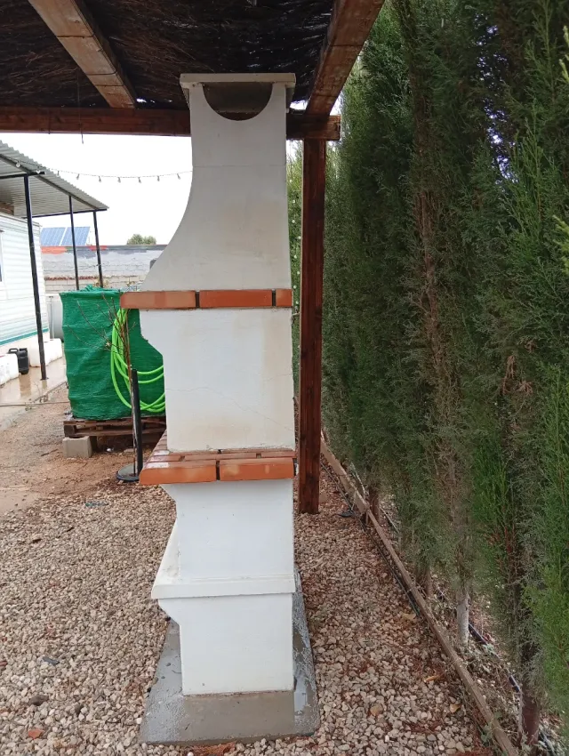 Barbacoa de ladrillo y hormigón con pérgola