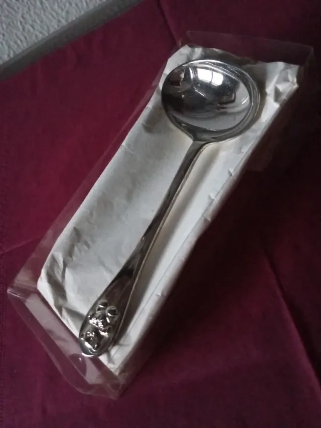 Cuchara de plata para bebé con osito en el mango.