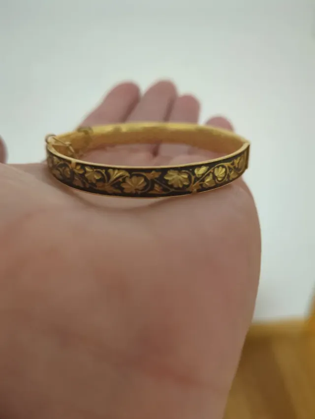 Pulsera color dorada con detalles negros