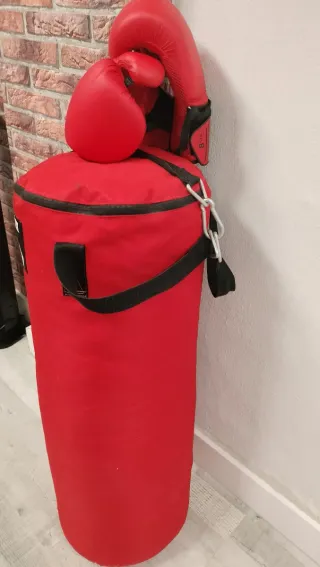 Saco de boxeo rojo y guantes.