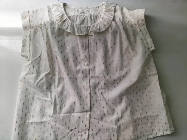 Camisa niña sin mangas con motivos dorados