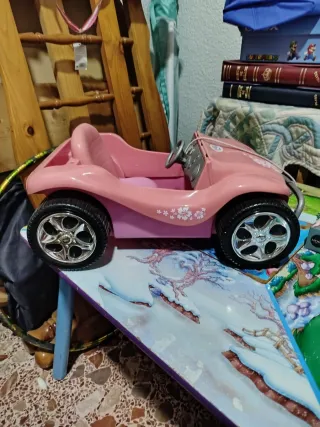 Cochecito rosa para muñecas
