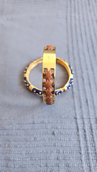 Dos pulseras doradas con detalles azules