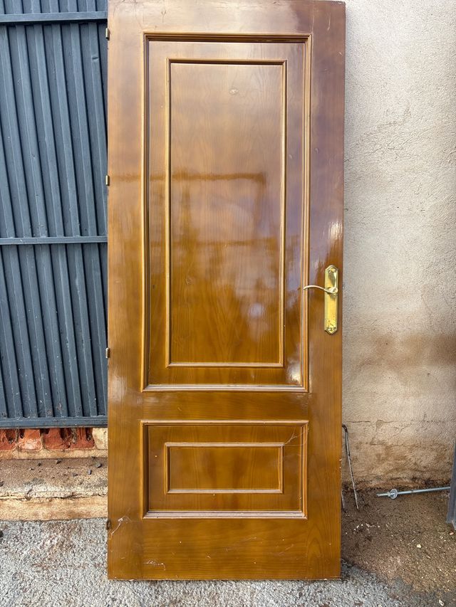 Puerta de madera con manilla dorada