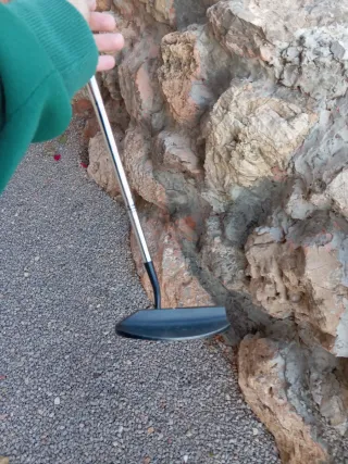 Palo de golf con etiqueta de advertencia