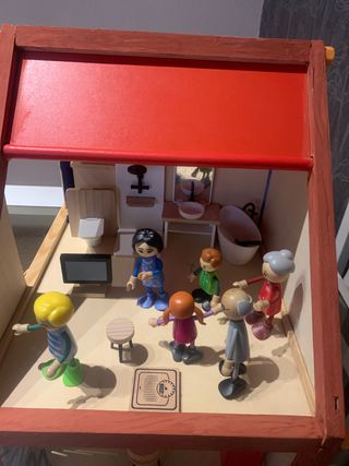 Casa de muñecas de madera con familia