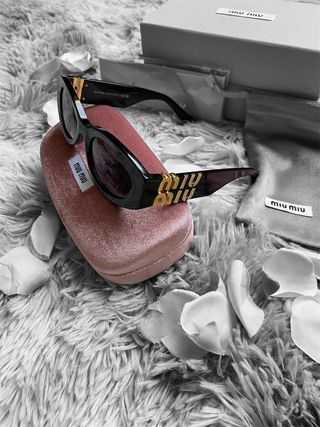 Occhiali da sole Miu Miu neri e oro