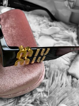 Occhiali da sole Miu Miu neri e oro