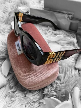 Occhiali da sole Miu Miu neri e oro