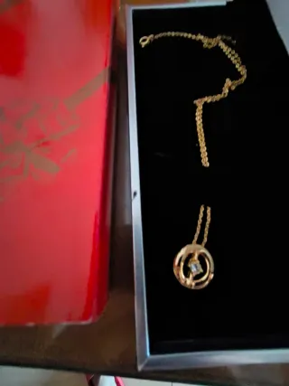 Colgante color oro con circonita.