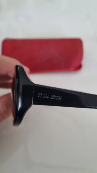 Occhiali da sole Miu Miu SMU04A neri