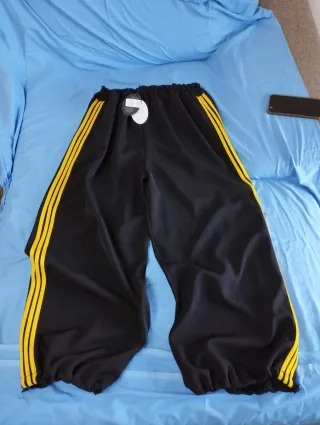 Pantaloni donna over neri con righe gialle