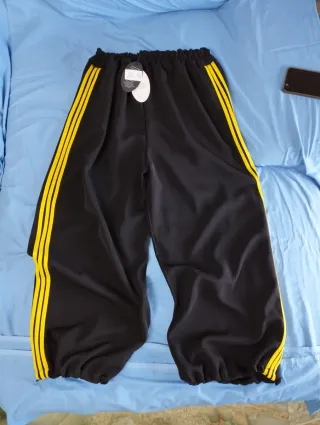 Pantaloni donna over neri con righe gialle