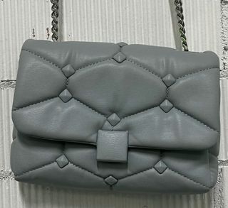 Bolso polipiel gris con cadena metalizada