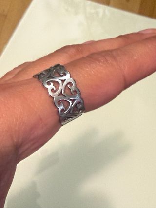 Anillo plateado con diseño de corazones