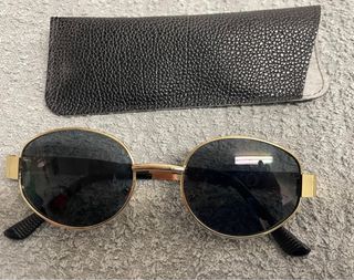 Gafas de sol ovaladas doradas y negras