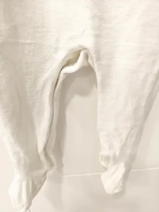 Pagliaccetto neonato bianco con trattore