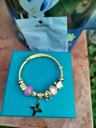 Pulsera dorada con charms rosas