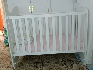 Cuna blanca con corazón rosa