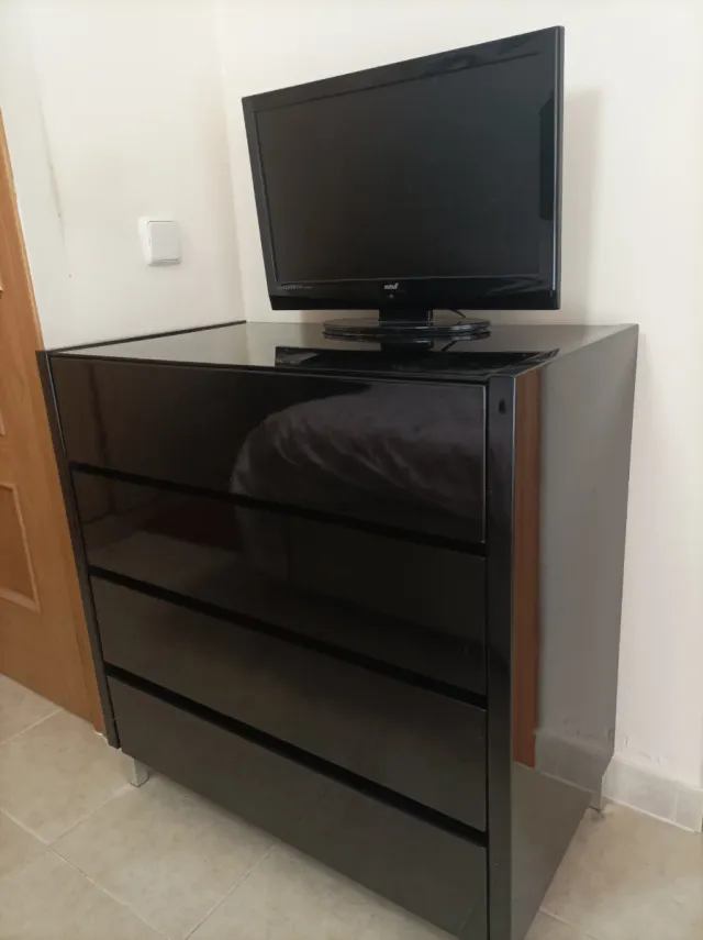 Cómoda negra lacada con superficie de cristal