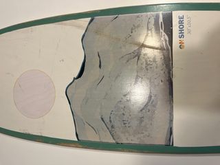 Tabla surfskate on shore skeleton bay