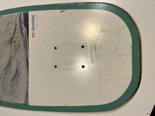 Tabla surfskate on shore skeleton bay